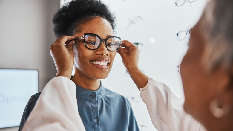 Woman trying on eyeglasses