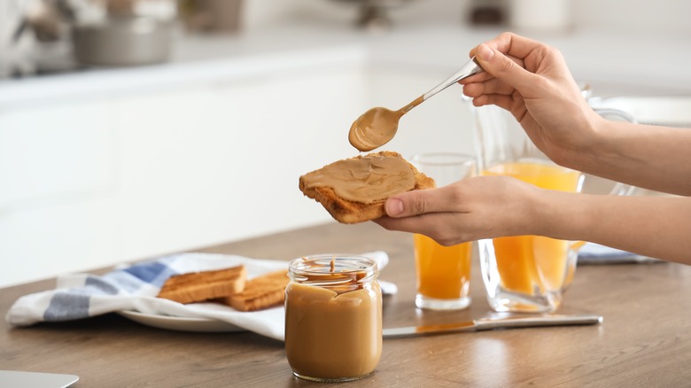 spreading peanut butter
