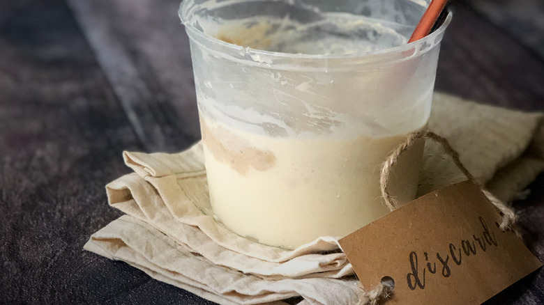 container of sourdough starter labeled discard