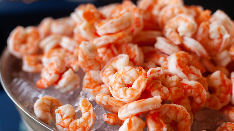 A pile of small shrimp on ice in a bowl.