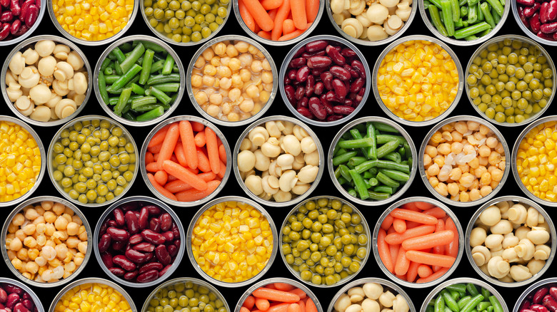 Opened canned vegetables lined up next to each other.