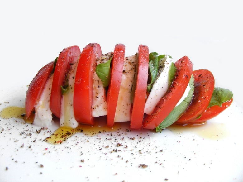 Tomatoes, mozzarella, basil, salt, pepper and olive oil, all you need to make a delicious Caprese salad