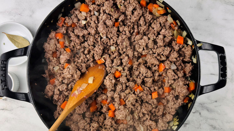 Ground lamb and vegetable mixture in pan
