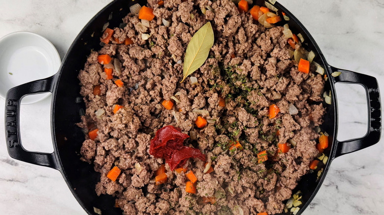 Ground lamb mixture with tomato paste and bay leaf