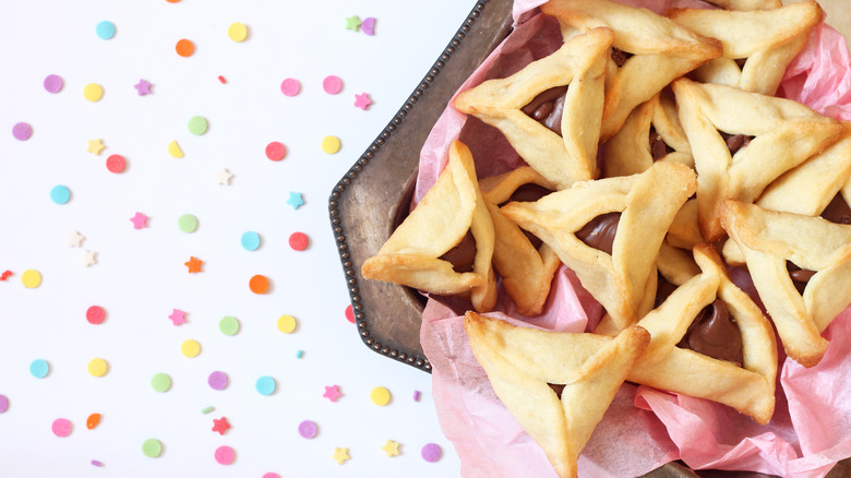 Platter of hamantaschen on confetti'd table