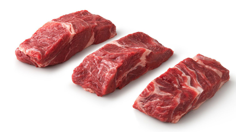 Raw country-style beef ribs.