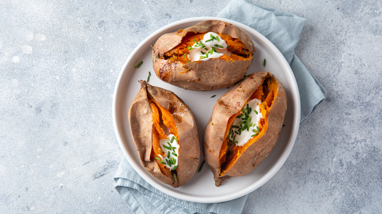 Creamy baked sweet potatoes with yogurt sauce.
