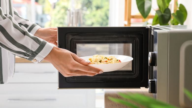 A person microwaving rice
