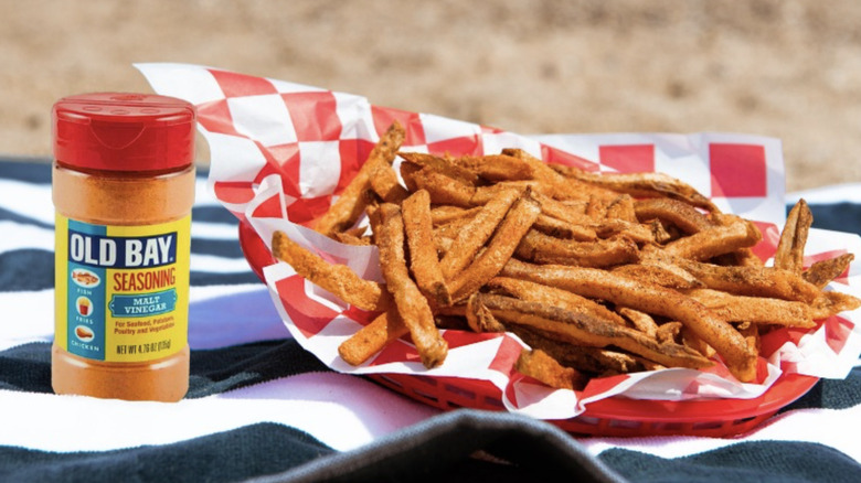 Old Bay seasoning next to fries on a beach