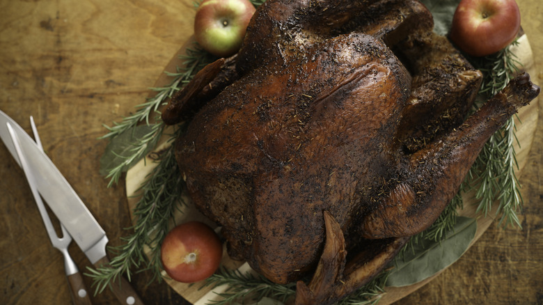 smoked thanksgiving turkey on wooden platter