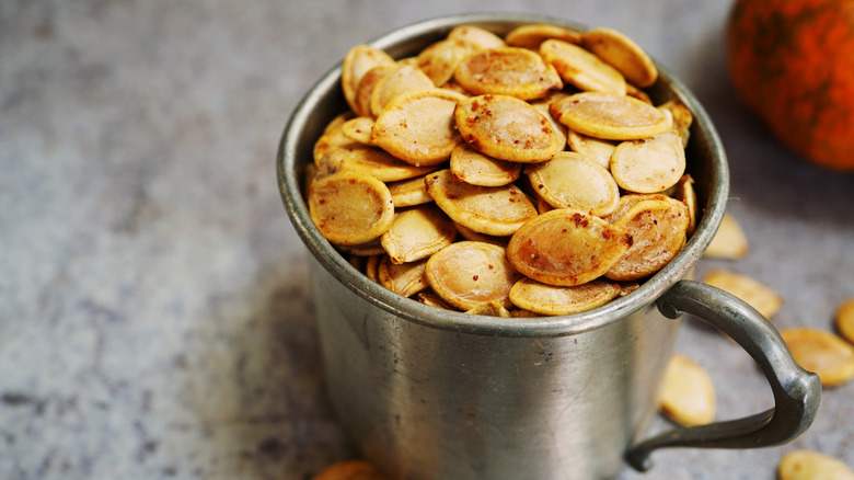 Silver cup of pumpkin seeds