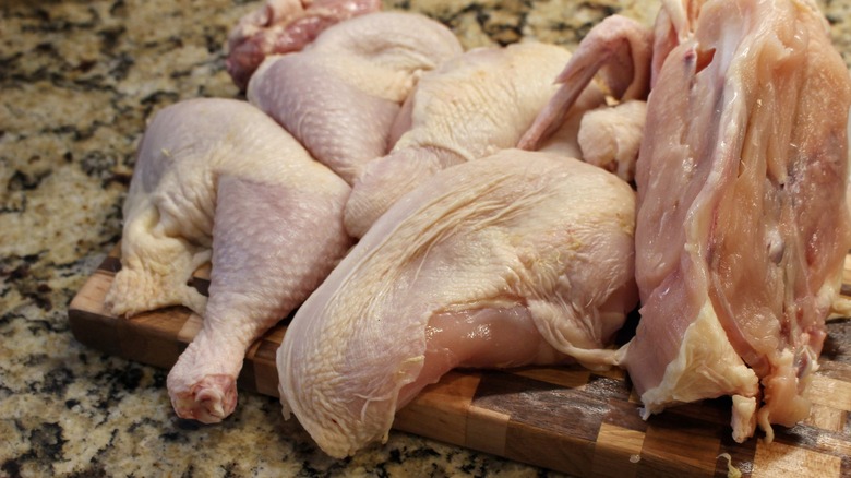 broken down chicken on cutting board