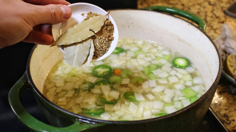 adding spices to soup