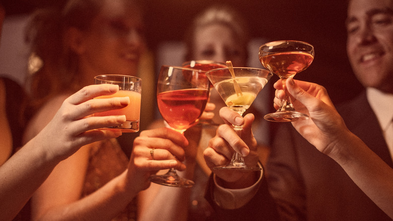 multiple cocktails being used in a cheers