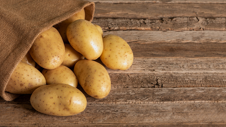Potatoes spilling out of a burlap sack