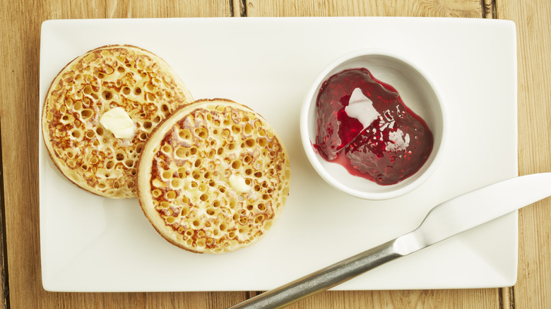 English muffin next to bowl of jam