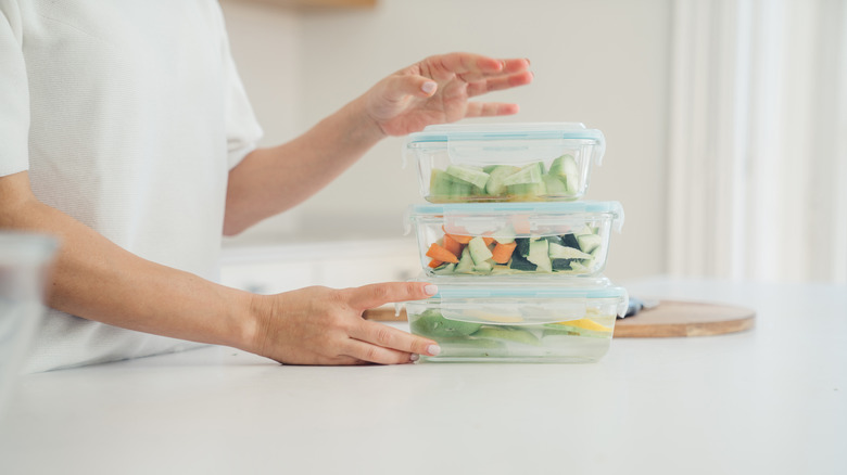 Woman with plastic Tupperware