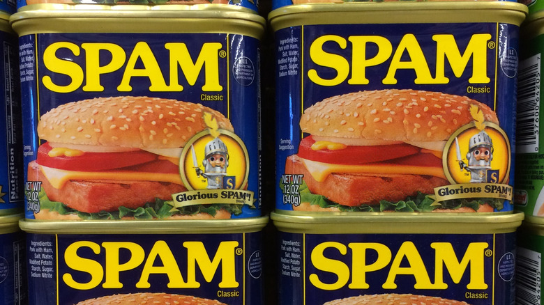 Cans of Spam sold on a shelf.