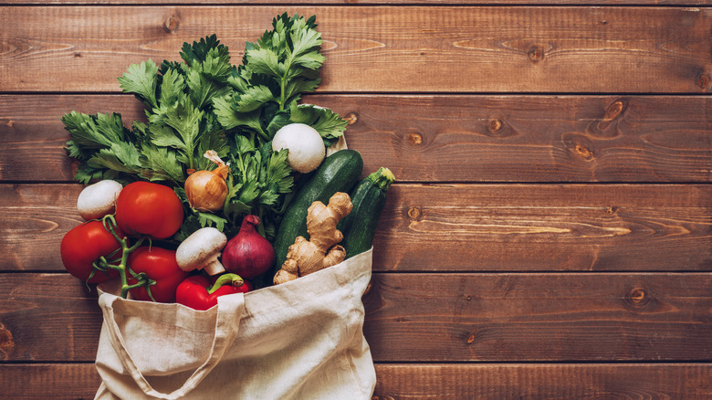 vegetables spilling from reusable bag