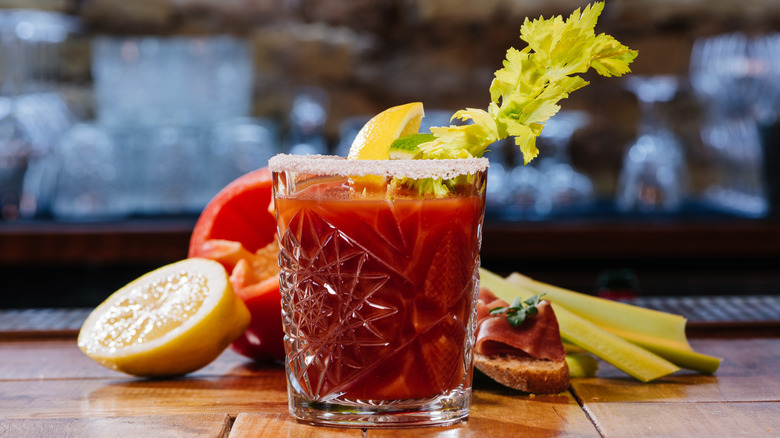 Bloody mary in a glass garnished with celery and citrus