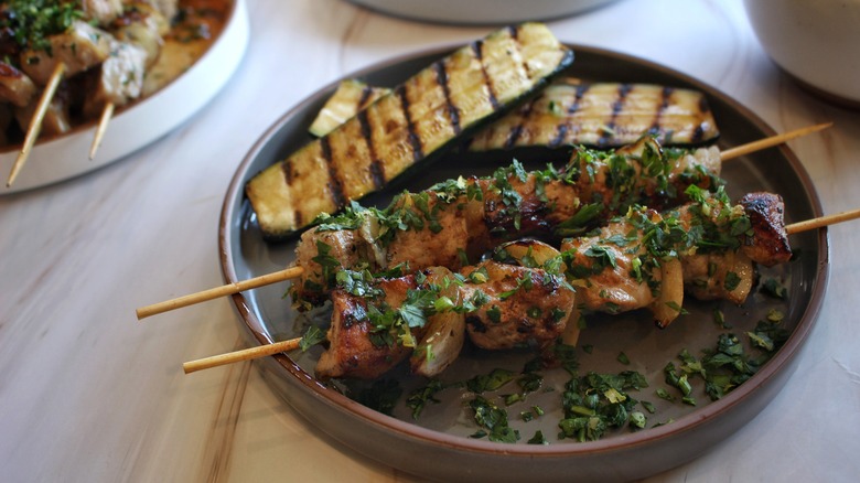 pork skewers zucchini on plate
