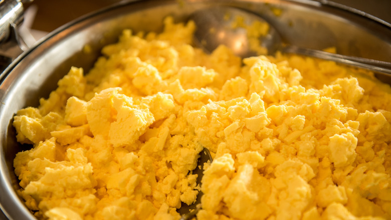 Pan of scrambled eggs with spoon