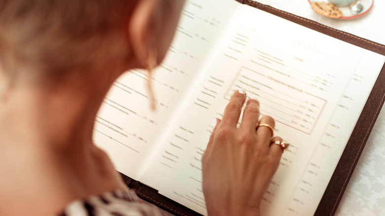 A woman reading a restaurant menu