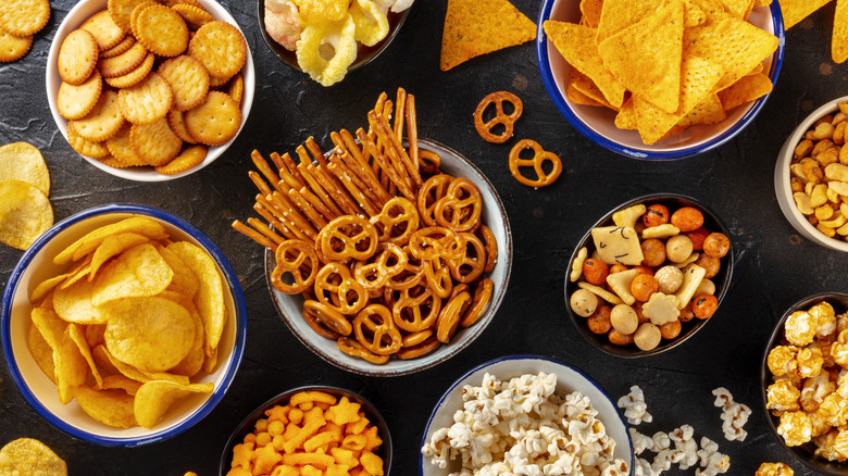 A variety of snacks in bowls on a table