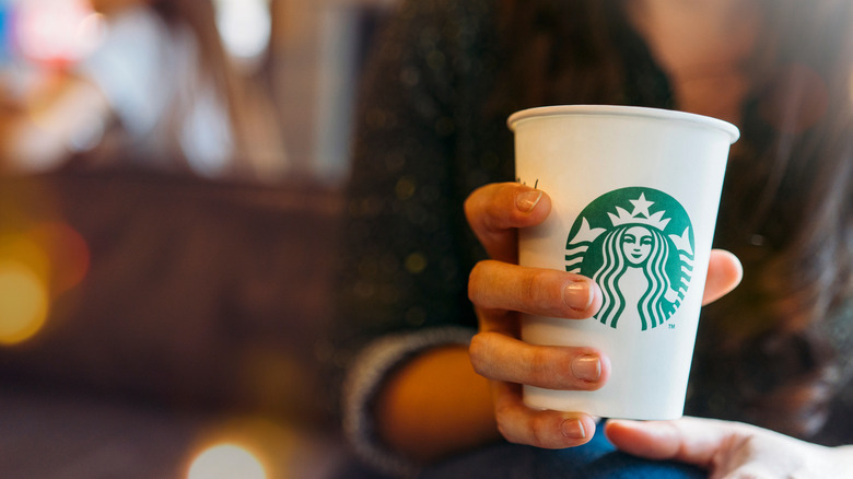 Starbucks customer holding coffee