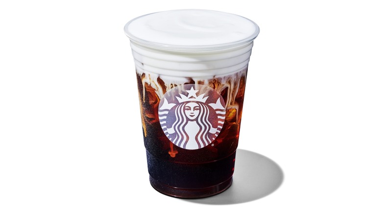A Starbucks cold brew coffee with sweet cream cold foam on top against a white background