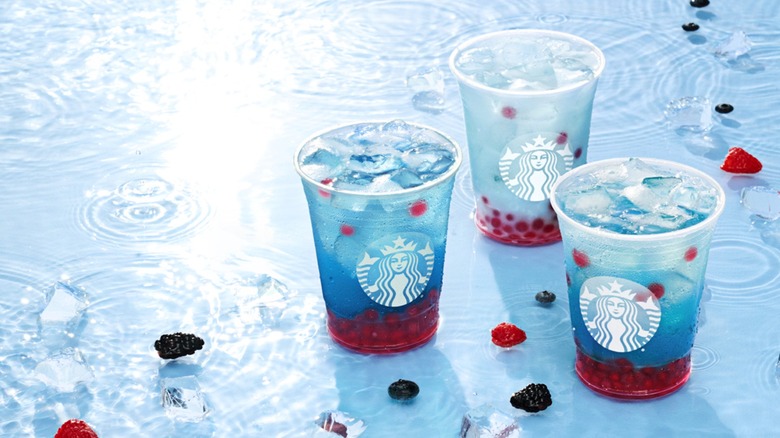 Three iced Starbucks Summer-Berry Refreshers with popping raspberry boba
