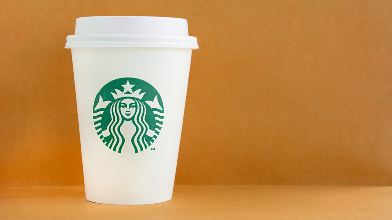 Starbucks cup against brown background
