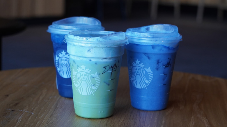 Side view of Starbucks' Blue Coconut Lemonade Refresher, Iced Blue Coconut Matcha, and Ocean Drink.