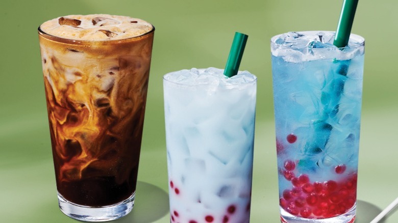 Images of items from Starbucks' new summer 2025 menu against a green background: Iced Horchata Oatmilk Shaken Espresso, Summer Skies Drink, Summer-Berry Lemonade Refresher, and Strawberries & Cream Cake Pop