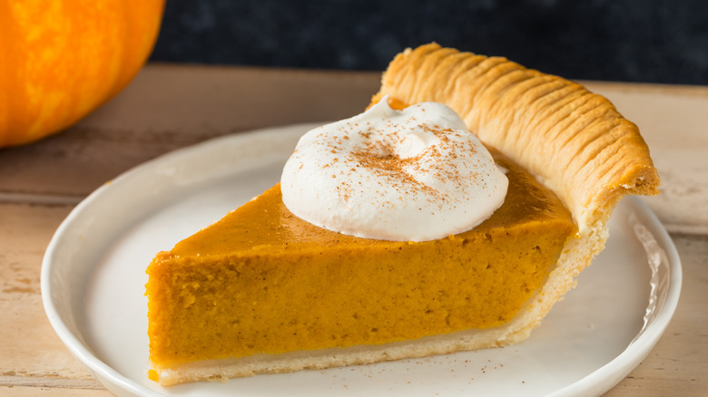 pumpkin pie slice with whipped cream