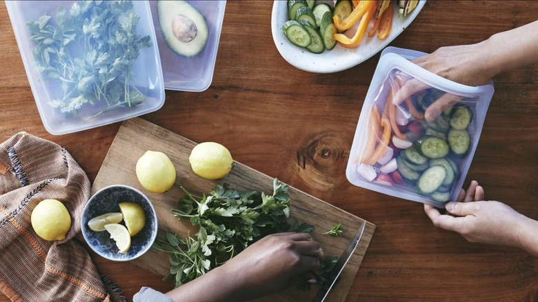 Bags and bowls with herbs and vegetables
