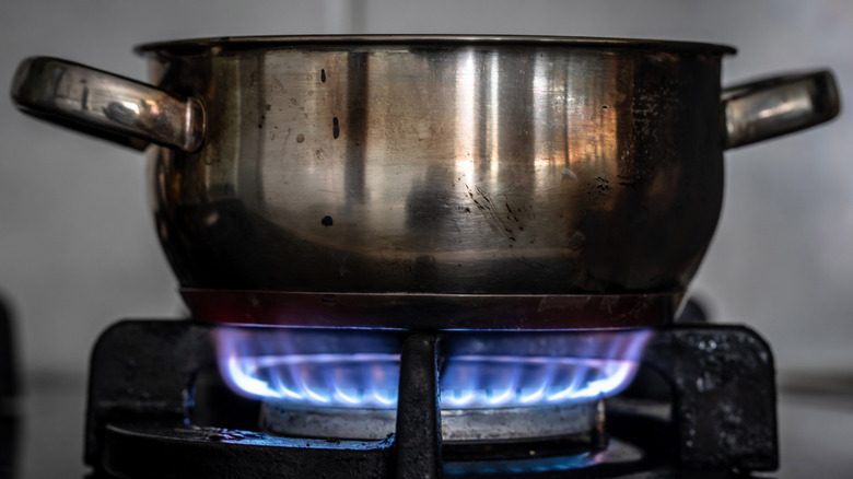 Metal pot over gas burner