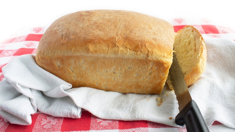 Knife slicing into bread
