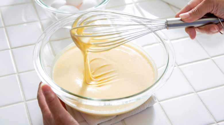 A large bowl on pancake mix being whisked
