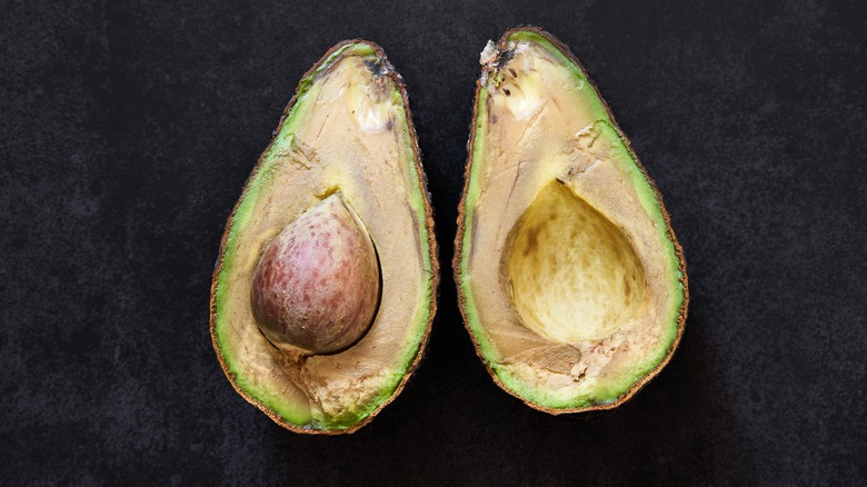 A halved and browned avocado