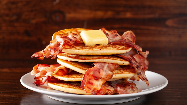 Pancakes topped and layered with bacon