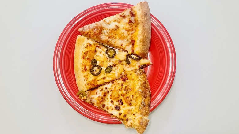 Three slices of stuffed crust pizza on a red plate