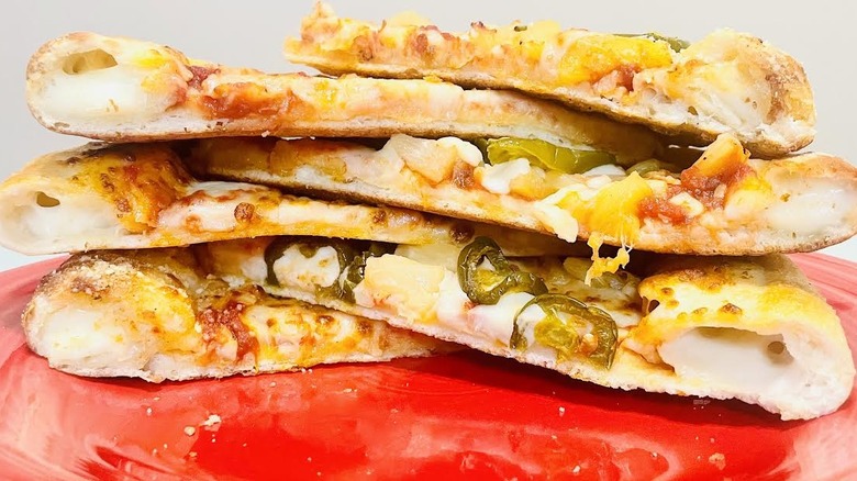 Side view of stacked stuffed crust pizza slices