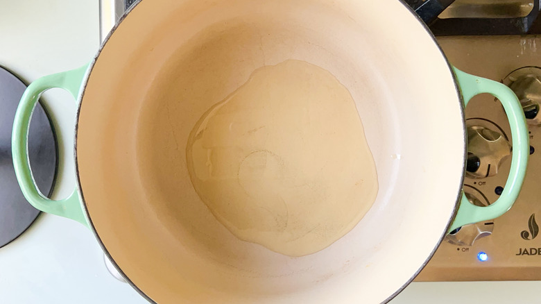 Heating oil in pot on stove