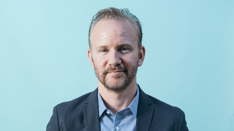 Morgan Spurlock against blue background