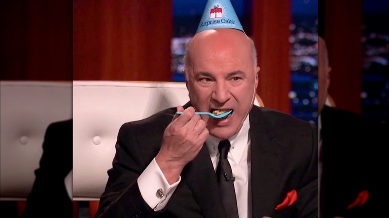 Mr. Wonderful eating cake wearing cone hat