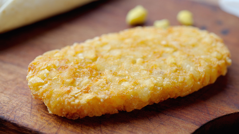 Closeup of hash brown patty on a cutting board