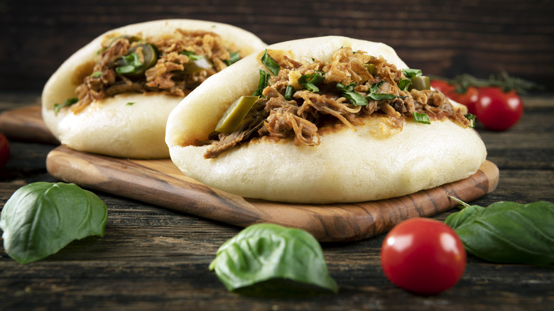 Bao buns filled with shredded meat and jalapenos