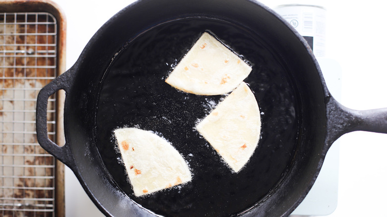 Tortillas frying in pan