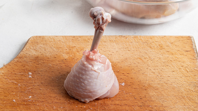 chicken drumstick on cutting board